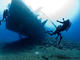 Certified divers diving from boat